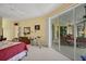 Bedroom with an exercise bike, patio access, and ample natural light at 5509 Grove Mnr, Lady Lake, FL 32159