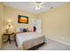 Well-lit bedroom with carpeted floors, double bed, and neutral walls at 5509 Grove Mnr, Lady Lake, FL 32159