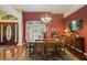 Dining area with chandelier, wood floors, and an elegant table at 5509 Grove Mnr, Lady Lake, FL 32159