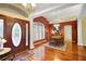 Dining room with wooden table, chandelier, and red accent wall at 5509 Grove Mnr, Lady Lake, FL 32159