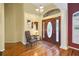 Elegant entryway featuring hardwood floors, decorative chair, and stained-glass door at 5509 Grove Mnr, Lady Lake, FL 32159