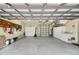Two-car garage with built-in storage cabinets, workbench, and epoxy flooring at 5509 Grove Mnr, Lady Lake, FL 32159