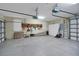 Spacious two-car garage with storage cabinets and organization system at 5509 Grove Mnr, Lady Lake, FL 32159