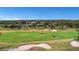 Golf course view with lush green fairways, sand traps, and golf carts at 5509 Grove Mnr, Lady Lake, FL 32159