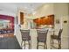 Kitchen with breakfast bar, stainless steel appliances, and wood cabinetry at 5509 Grove Mnr, Lady Lake, FL 32159
