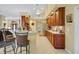 Kitchen with stainless steel appliances, wood cabinetry, and a breakfast bar at 5509 Grove Mnr, Lady Lake, FL 32159