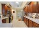 Bright kitchen featuring wood cabinets, stainless steel appliances, and tile flooring at 5509 Grove Mnr, Lady Lake, FL 32159