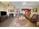 Spacious living room with leather furniture, fireplace, and entryway views at 5509 Grove Mnr, Lady Lake, FL 32159