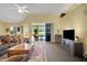 Living room with view of the pool, sliding glass doors, and high ceilings at 5509 Grove Mnr, Lady Lake, FL 32159