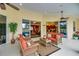 Relaxing patio with wicker furniture, ceiling fans, and views of the pool and living room at 5509 Grove Mnr, Lady Lake, FL 32159