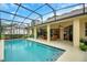 The screened pool area provides backyard access and views of the golf course at 5509 Grove Mnr, Lady Lake, FL 32159
