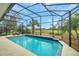 Inviting pool and screen enclosure overlooking the golf course at 5509 Grove Mnr, Lady Lake, FL 32159