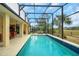 Screened-in pool area provides picturesque golf course views at 5509 Grove Mnr, Lady Lake, FL 32159