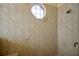 Walk-in shower with tile walls and an octagon-shaped window at 5509 Grove Mnr, Lady Lake, FL 32159