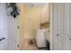 Bright laundry room with washer, dryer, and utility sink at 5717 Illumination Ln, Leesburg, FL 34748