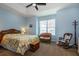 Bright and airy main bedroom with wicker furniture and lake view at 5717 Illumination Ln, Leesburg, FL 34748