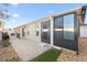 Home exterior view showcasing a back patio and sunroom at 893 Parrish Pl, The Villages, FL 32163