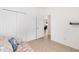 Well-lit bedroom with double doors leading to another room at 893 Parrish Pl, The Villages, FL 32163