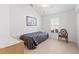 Small bedroom with chair and window with plantation shutters at 893 Parrish Pl, The Villages, FL 32163