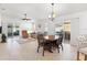 Dining area with tile floors, chandelier, and access to the patio at 893 Parrish Pl, The Villages, FL 32163