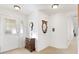 Entryway with tiled floors, coat rack, and a decorative mirror at 893 Parrish Pl, The Villages, FL 32163