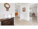 Bright entryway with tiled floor, wooden console table, and view to kitchen at 893 Parrish Pl, The Villages, FL 32163