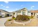 Single story house with landscaped yard, driveway, and a light post at 893 Parrish Pl, The Villages, FL 32163