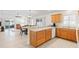 Kitchen with light oak cabinets, white appliances, and a breakfast bar at 893 Parrish Pl, The Villages, FL 32163