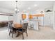 Bright kitchen with wood cabinets, tile floor, and breakfast bar at 893 Parrish Pl, The Villages, FL 32163