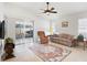 Spacious living room with tile floors, comfy seating, and access to a lanai at 893 Parrish Pl, The Villages, FL 32163