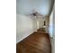 Bright bedroom featuring mirrored closet doors and wood-look flooring at 926 Willow Dr, Leesburg, FL 34748