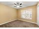 Bright bedroom with ceiling fan and neutral carpeting at 980 Vassar Dr, Eustis, FL 32726