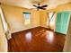 Bright bedroom with hardwood floors and teal closet doors at 100 W Myrtle St, Howey In The Hills, FL 34737