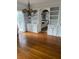 Open concept dining room with hardwood floors and kitchen view at 100 W Myrtle St, Howey In The Hills, FL 34737