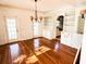 Spacious dining room with hardwood floors and views to backyard at 100 W Myrtle St, Howey In The Hills, FL 34737