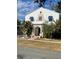 Two-story home with unique architectural details and landscaped yard at 100 W Myrtle St, Howey In The Hills, FL 34737
