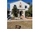 Charming two-story home with unique architectural details and lush landscaping at 100 W Myrtle St, Howey In The Hills, FL 34737