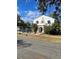 Two-story home with unique architectural details and street view at 100 W Myrtle St, Howey In The Hills, FL 34737