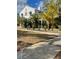 Two-story home showcasing side yard landscaping at 100 W Myrtle St, Howey In The Hills, FL 34737