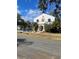 Two-story home with unique architectural details and street view at 100 W Myrtle St, Howey In The Hills, FL 34737