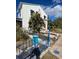 Blue metal fence and gate with mature landscaping at 100 W Myrtle St, Howey In The Hills, FL 34737