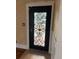 Black front door with glass and ornate iron accents at 100 W Myrtle St, Howey In The Hills, FL 34737