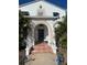 Inviting front porch with tiled steps and arched entryway at 100 W Myrtle St, Howey In The Hills, FL 34737