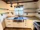 Kitchen with farmhouse sink, granite countertops, and stainless steel appliances at 100 W Myrtle St, Howey In The Hills, FL 34737