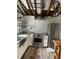 Modern kitchen features stainless steel appliances and exposed wooden beams at 100 W Myrtle St, Howey In The Hills, FL 34737