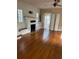 Living room with hardwood floors, fireplace, and built-in shelving at 100 W Myrtle St, Howey In The Hills, FL 34737