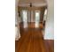 Spacious living room with hardwood floors and access to sunroom at 100 W Myrtle St, Howey In The Hills, FL 34737