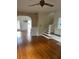 Living room with hardwood floors, fireplace, and staircase at 100 W Myrtle St, Howey In The Hills, FL 34737