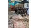 Outdoor patio with stone tile flooring, wooden table and chairs, and shade cover at 100 W Myrtle St, Howey In The Hills, FL 34737