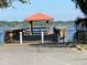Wooden pier extending into the lake with a covered area at 100 W Myrtle St, Howey In The Hills, FL 34737